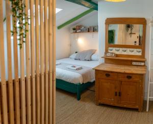 a small bedroom with a bed and a mirror at SURF HOSTEL BIARRITZ in Biarritz