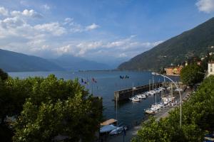 a body of water with boats docked at a dock at Apartment Laghée in Bellano