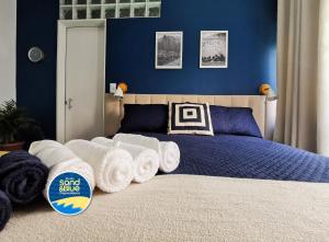 a bedroom with a bed with rolled towels on it at Studio Sand & Blue Copacabana Beach in Rio de Janeiro