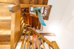 a person sitting on a staircase with a surfboard at SURF HOSTEL BIARRITZ in Biarritz