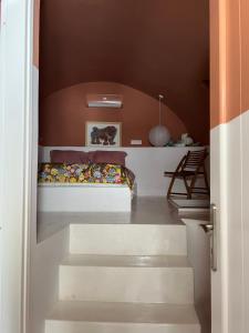 a bedroom with stairs leading to a bunk bed at IANUA Casa per Viaggiatori in Astypalaia