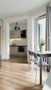 a kitchen and dining room with a table and chairs at Good Time Apartments Strzelecka C in Poznań