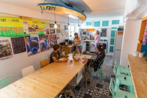 a group of people sitting at a table in a restaurant at SURF HOSTEL BIARRITZ in Biarritz
