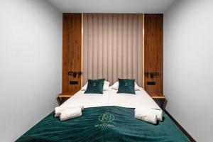 Postel nebo postele na pokoji v ubytování Restoria Hotel***