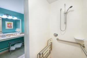 a bathroom with a shower and a sink at voco Sarasota, an IHG Hotel in Sarasota