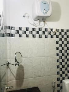 a bathroom with a mirror and a camera on the wall at GreenSenz Resort & Hostel-Sigiriya in Sigiriya +45 photos
