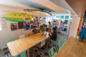 a group of children sitting at a table in a kitchen at SURF HOSTEL BIARRITZ in Biarritz +37 photos