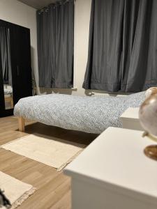 een slaapkamer met een bed op een houten vloer bij BelloHome in La Bretagne