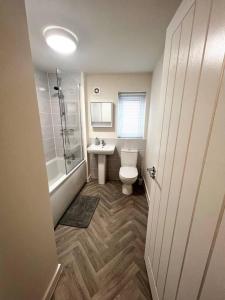 a bathroom with a toilet and a sink and a shower at Beautiful 3-Bed House in Bradford in Bradford