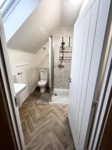 a bathroom with a shower and a toilet and a sink at Beautiful 3-Bed House in Bradford in Bradford