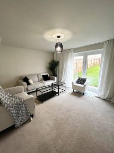 a living room with a couch and a table at Beautiful 3-Bed House in Bradford in Bradford