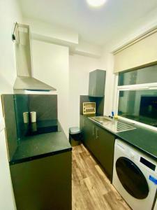 a kitchen with a sink and a stove at Stylish one bed Studio Flat Edgware Road In Central London in London
