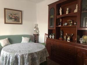 a bedroom with a bed and a wooden dresser at La chimenea de la tía engracia in Ruidera +3 photos