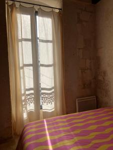 a bedroom with a bed and two large windows at Pop'Arles in Arles