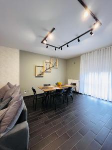 a living room with a table and chairs and a couch at Berlen Home apartment in Torre Maggiore