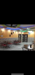 a room with tables and chairs and a stone wall at Hotel Nest Park Street in Kolkata