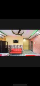 a room with a red bed in a room at Hotel Nest Park Street in Kolkata