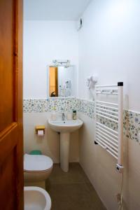 a bathroom with a sink and a toilet and a mirror at RossoToscano 