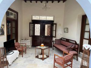 a living room with a couch and chairs and a table at Charming 1800s House - Lefkara Village Retreat in Pano Lefkara