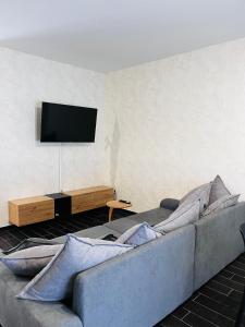 a living room with a couch and a flat screen tv at Berlen Home apartment in Torre Maggiore