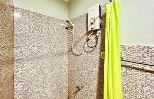 bagno con doccia e tenda verde di M & M's Home stay at Palawan Casa a Città di Puerto Princesa