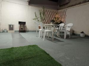 a table and chairs with a christmas tree in a room at Trikala Alex House in Tríkala