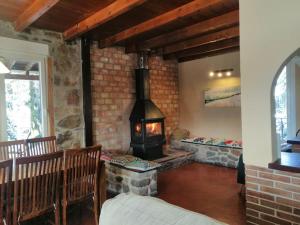a fireplace in a room with a brick wall at El Rincon del Tejo in Herreros