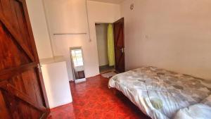 a bedroom with a bed and an open door at Jabulani Nairobi Backpackers Hostel in Nairobi