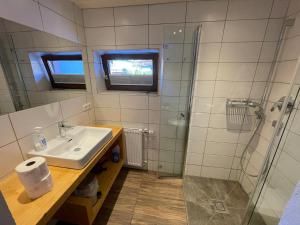 a bathroom with a sink and a shower at Gästehaus Katharina in Hochfilzen +45 photos
