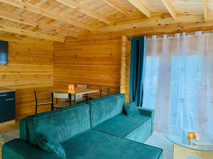 a living room with a couch and a table at CHALET EN BOIS PRIVATIF ST POURCAIN SUR SIOULE in Bransat