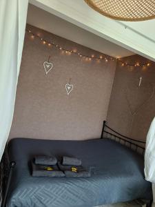 a bedroom with a bed with hearts on the wall at Couturier lovely appartement proche centre ville in Reims