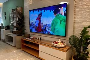 a living room with a flat screen tv on a wall at Apto Luxuoso, 50 Mts da Praia em Copacabana para 6 in Rio de Janeiro