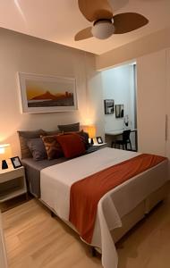 a bedroom with a large bed with a ceiling fan at Apto Luxuoso, 50 Mts da Praia em Copacabana para 6 in Rio de Janeiro
