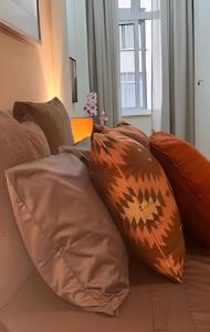 a pile of pillows sitting on top of a couch at Apto Luxuoso, 50 Mts da Praia em Copacabana para 6 in Rio de Janeiro