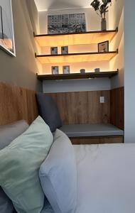 a bedroom with a bed and a bench and a building at Apto Luxuoso, 50 Mts da Praia em Copacabana para 6 in Rio de Janeiro