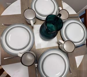 a group of plates and spoons on a table at Apto Luxuoso, 50 Mts da Praia em Copacabana para 6 in Rio de Janeiro