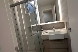 a bathroom with a sink and a mirror at Apto Luxuoso, 50 Mts da Praia em Copacabana para 6 in Rio de Janeiro