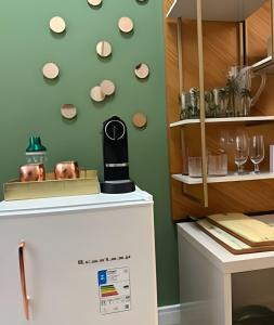 a refrigerator in a kitchen with plates on the wall at Apto Luxuoso, 50 Mts da Praia em Copacabana para 6 in Rio de Janeiro