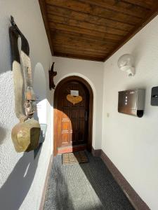 a hallway of a house with a door and a television at Gästehaus Katharina in Hochfilzen