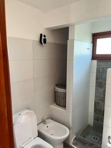 a small bathroom with a toilet and a shower at Hermoso quincho a pasos del mar in Playa Verde