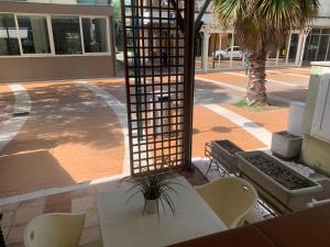 a patio with a table and chairs and a building at Appartamenti Belle Vacanze in Cattolica