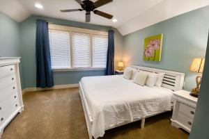 - une chambre avec un lit blanc et une fenêtre dans l'établissement Barefoot Bungalo, à Destin