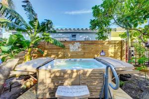 a hot tub in a yard with a fence at Garden Beach studio @The Island in Deerfield Beach