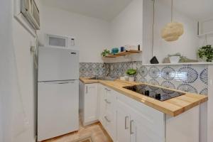a kitchen with a white refrigerator and a wooden counter top at Garden Beach studio @The Island in Deerfield Beach