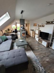a living room with a couch and a fireplace at Ferienwohnung 2 - a72142 in Wangerland