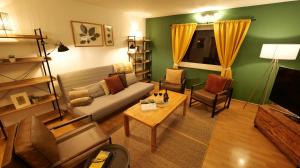 a living room with a couch and a table at Plant Apartment - Großer Balkon mit Grill - Schwarzwald und Schwäbische Alb in Eutingen +32 photos