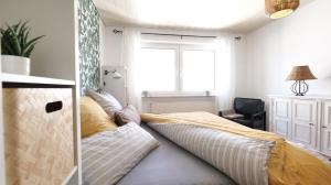 a bedroom with a large bed with a large window at Plant Apartment - Großer Balkon mit Grill - Schwarzwald und Schwäbische Alb in Eutingen