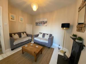 a living room with a couch and a coffee table at Seaview Cottage in Broadstairs