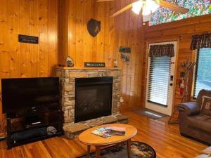 a living room with a fireplace and a tv at Beary Tale! Your happily ever after starts here! in Sevierville
