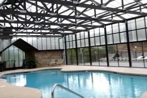 a large swimming pool with a large building with windows at Beary Tale! Your happily ever after starts here! in Sevierville